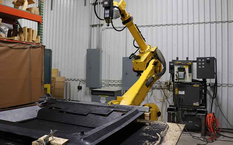 Another robot cuts plastic pieces for Headliners and Cowl Kits at HyCapacity